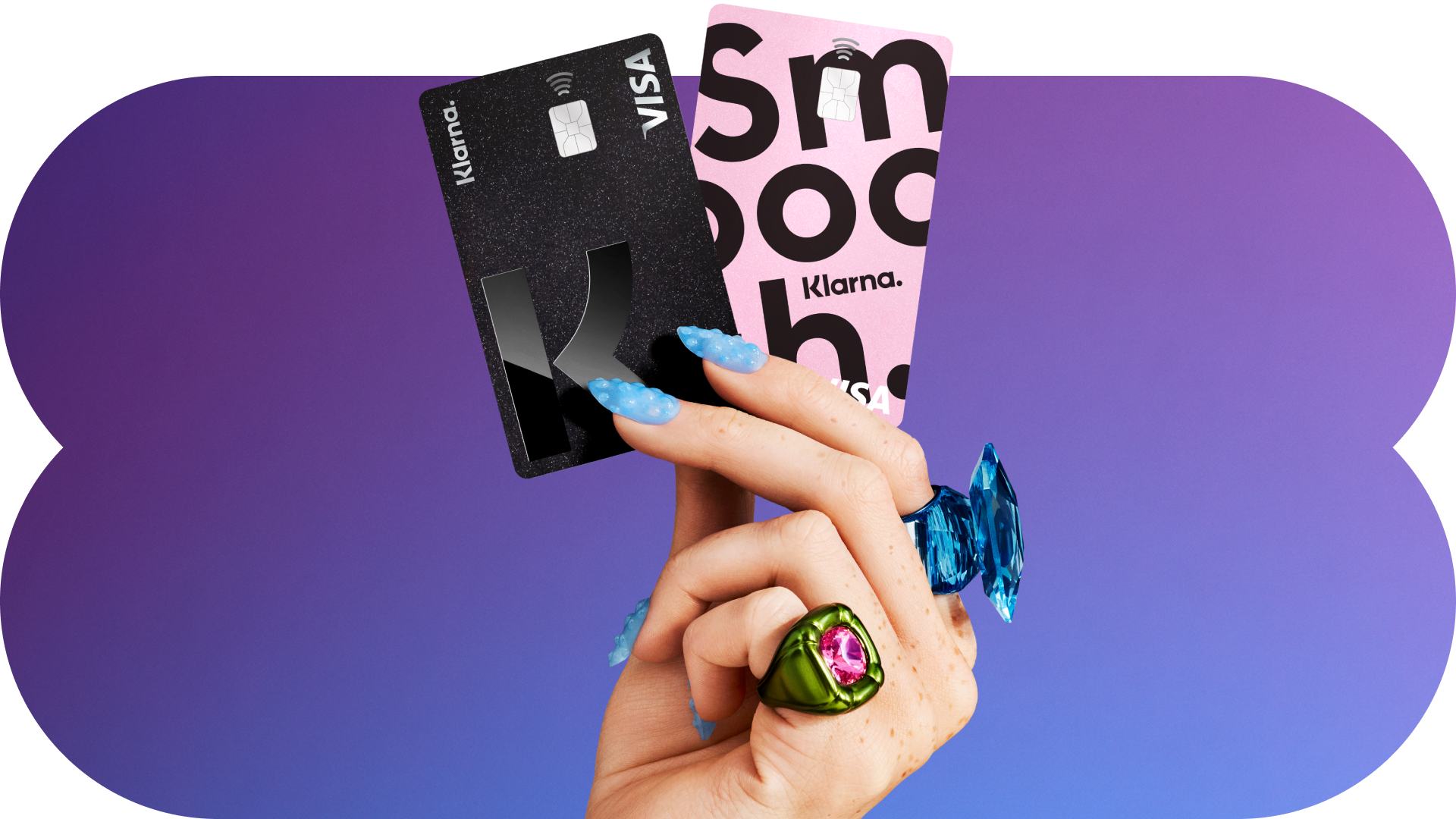 Klarna debit cards held against a purple gradient backdrop